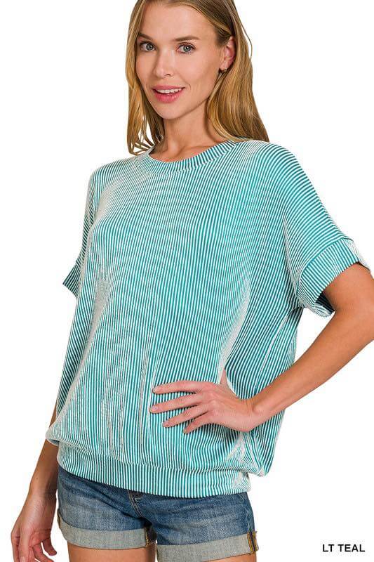 Woman wearing the Coastal Current Ribbed Top in teal, showcasing its lightweight ribbed texture and relaxed fit.