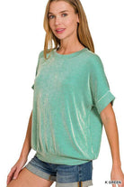 Woman wearing a Kelly Green Coastal Current Ribbed Top, featuring a relaxed fit and casual style.