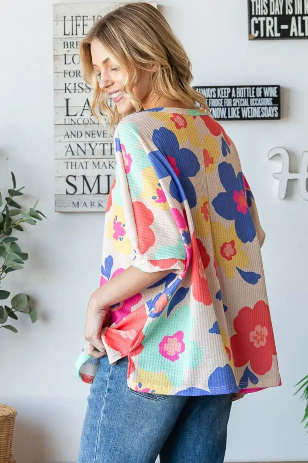 Floral oversized top in waffle knit with vibrant colors, perfect for adding whimsy to any outfit.