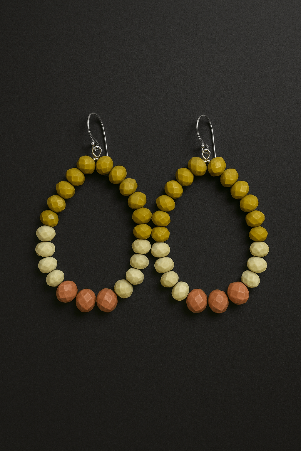Cherish Beaded Teardrop Earrings in yellow, cream, and peach colors against a dark background, showcasing a lightweight design.