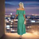 Woman in green polka dot maxi dress, off-the-shoulder style, showcasing versatility for casual outings or special occasions.