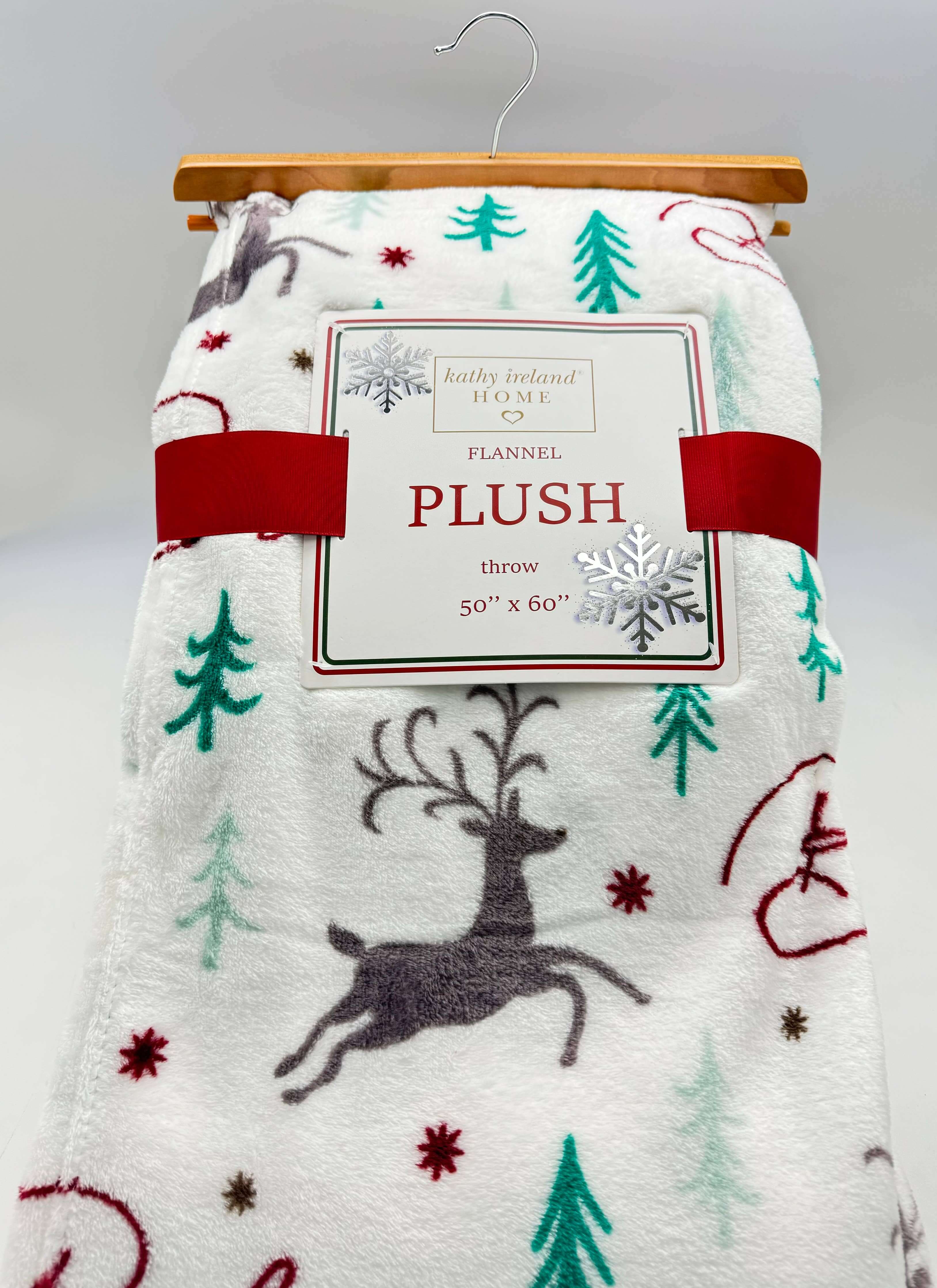 Kathy Ireland Christmas Cheer Plush Throw Blanket with festive reindeer and tree design, flannel fleece, 50x60 inches.