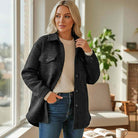 WARM IMPRESSIONS BUTTON DOWN black quilted shacket worn by woman indoors with natural light.