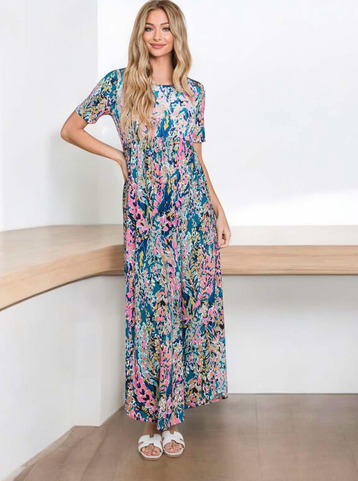 Watercolor Wonder maxi dress with colorful floral design, worn by model in a relaxed fit, perfect for summer.