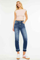 Model wearing KANCAN Georgia Ultra High Rise Slim Straight Leg Jeans with a light top and sneakers.