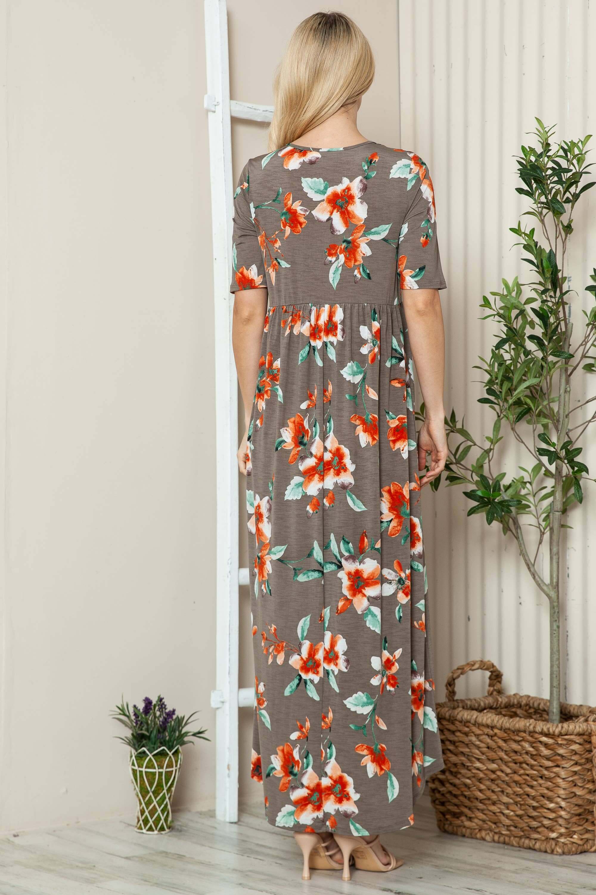 Women's floral shirred maxi dress with short sleeves in a flowy silhouette, model shown from back.