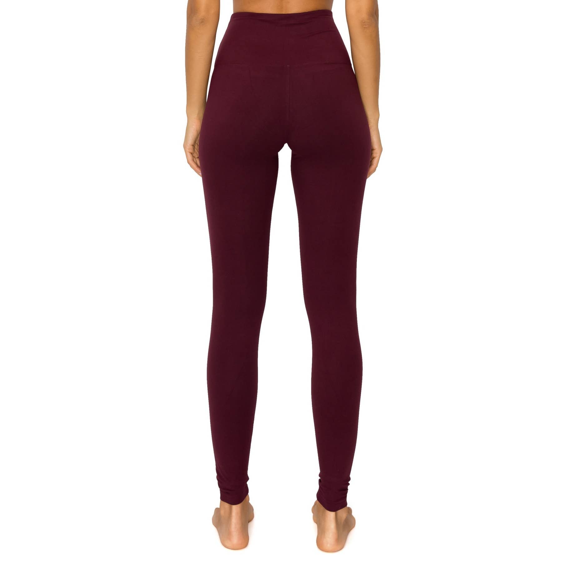 Woman wearing burgundy FIND YOUR BALANCE leggings with a 5" yoga band for a secure fit, showcasing a buttery soft fabric.