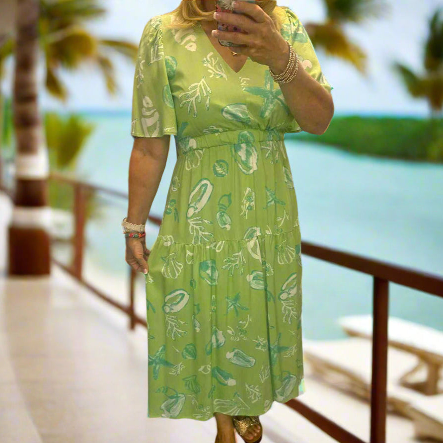 Lime green midi dress with seashell print, perfect for summer beach outings and casual brunches.