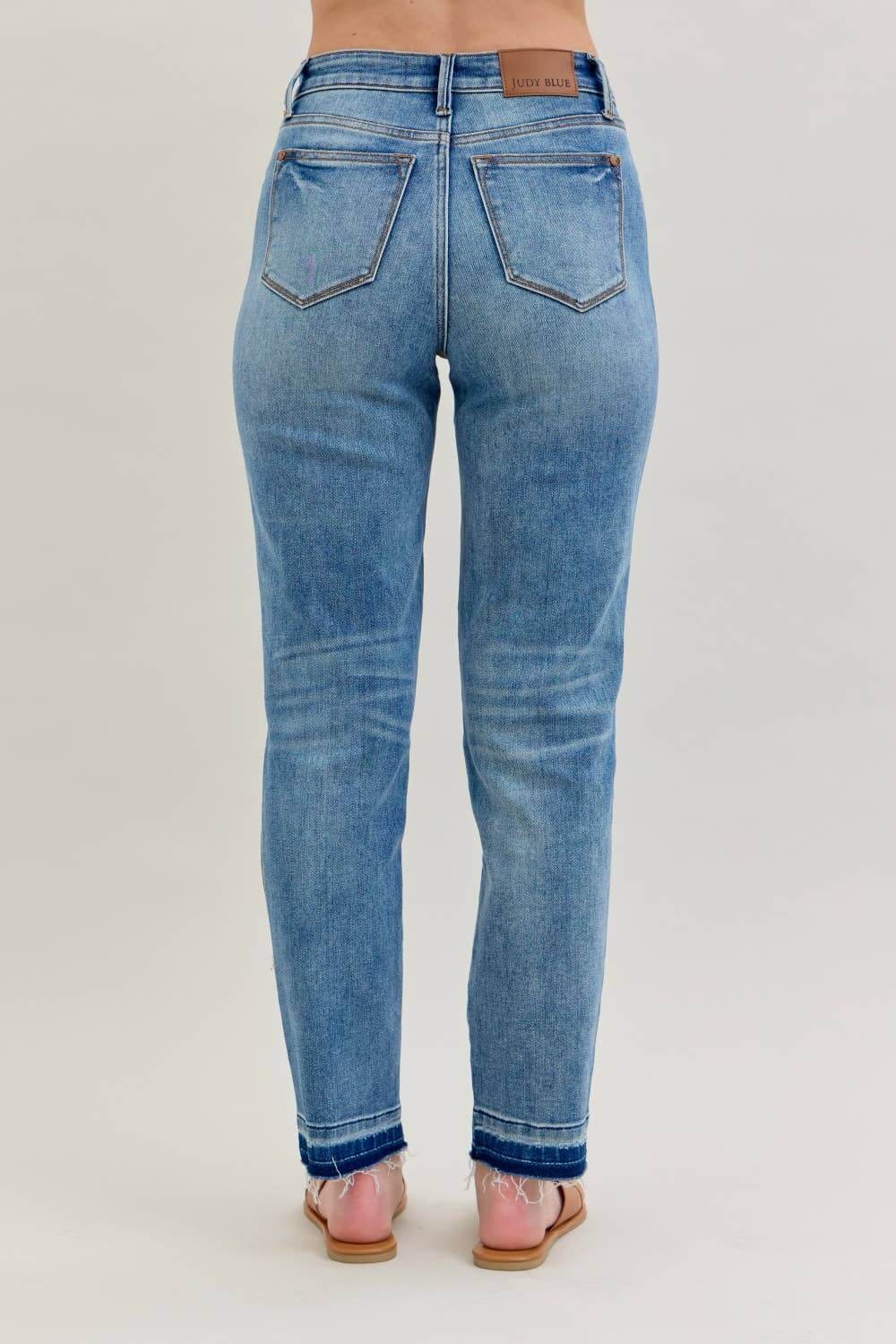 Back view of JUDY BLUE - AVERY JEANS showcasing the modern release hem detail and relaxed boyfriend cut.