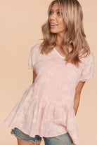 Model wearing the Grace & Glam Top by Haptics, showcasing its floral texture and flowy babydoll silhouette.