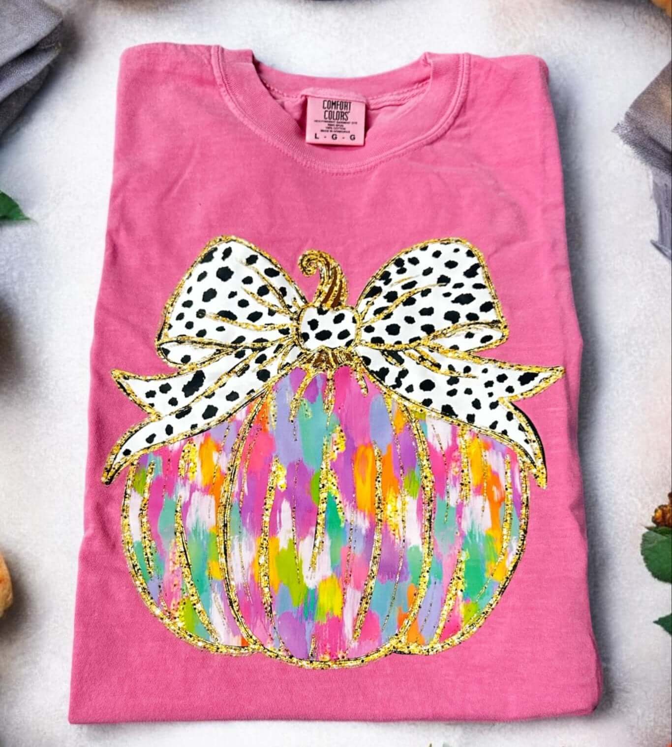 Pink Crunchberry Pumpkin Art Tee with vibrant pumpkin and polka dot bow applique. Super soft Comfort Color cotton t-shirt.