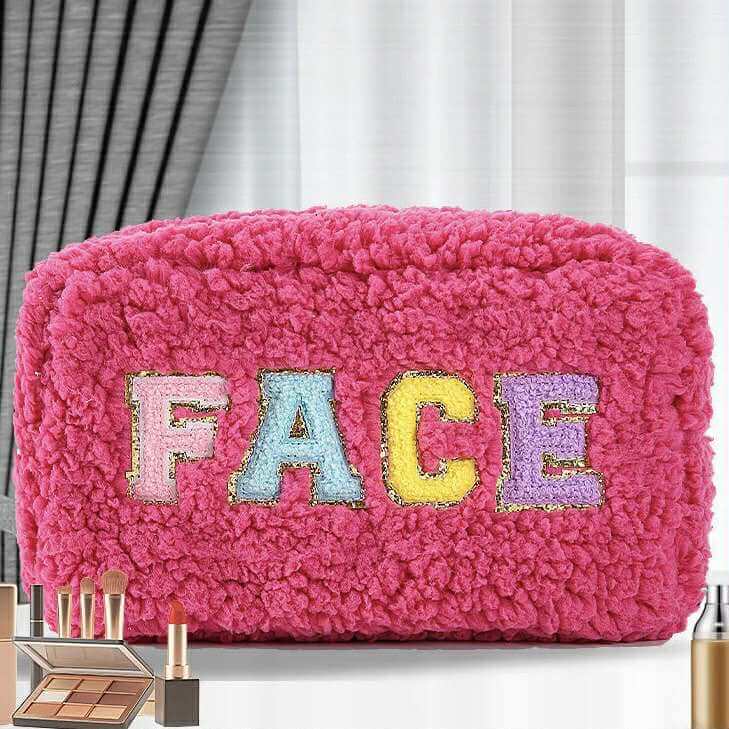 Pink plush chenille cosmetic bag with colorful chenille patch letters spelling 'FACE' and gold accents.