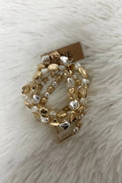 Dorianne Beaded Bracelet Set with gold and silver beads on a white furry background.