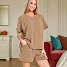 Woman in toffee ribbed 2-piece shorts set, showcasing relaxed fit and cozy style, perfect for fall lounging.