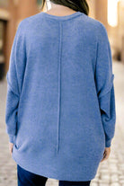 A model wearing a blue sweater from CLOUDY SKY - ZENANA, showcasing a cozy and stylish back design.