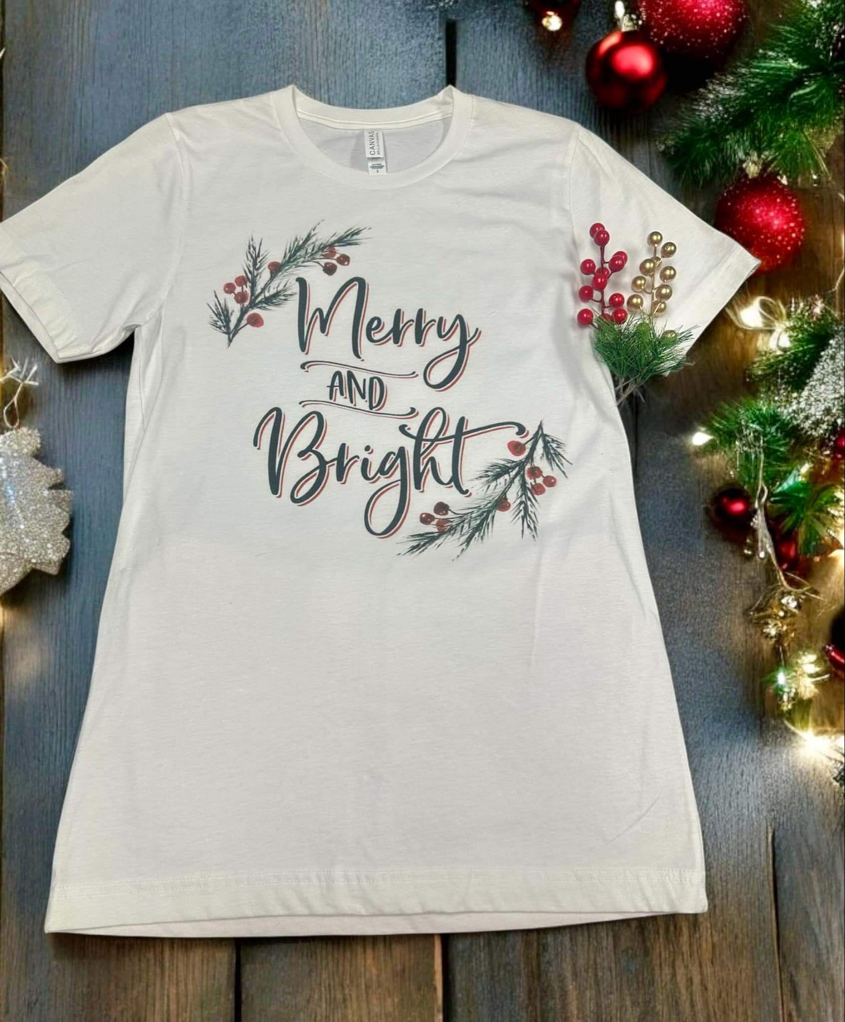 Merry and Bright tee by Bella Canvas, white t-shirt with holiday design and Holly trim, 100% cotton.