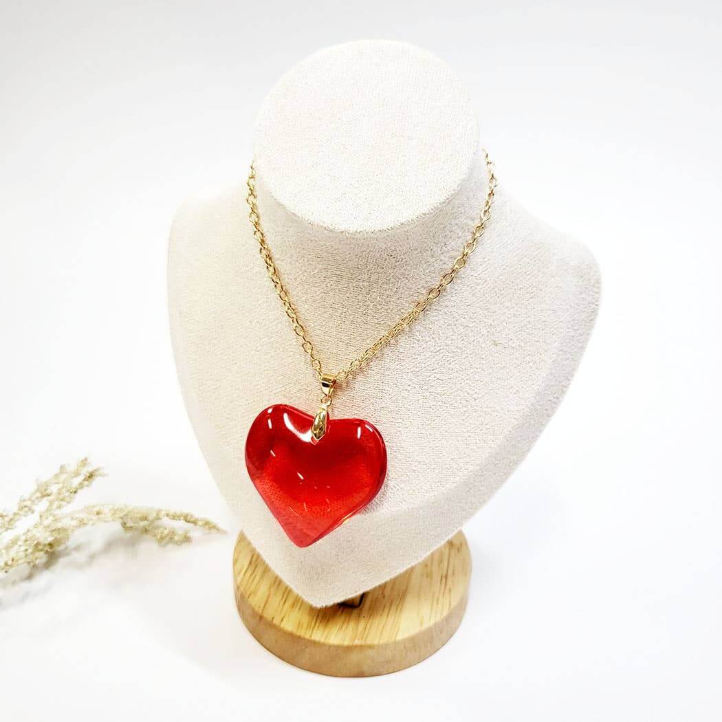 Valentine's Day heart-shaped pendant necklace in red displayed on a jewelry bust. Perfect gift for loved ones.