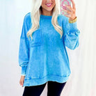 OCEAN MIST PULLOVER model wearing a blue mineral wash sweatshirt with raw seams and patched pocket.