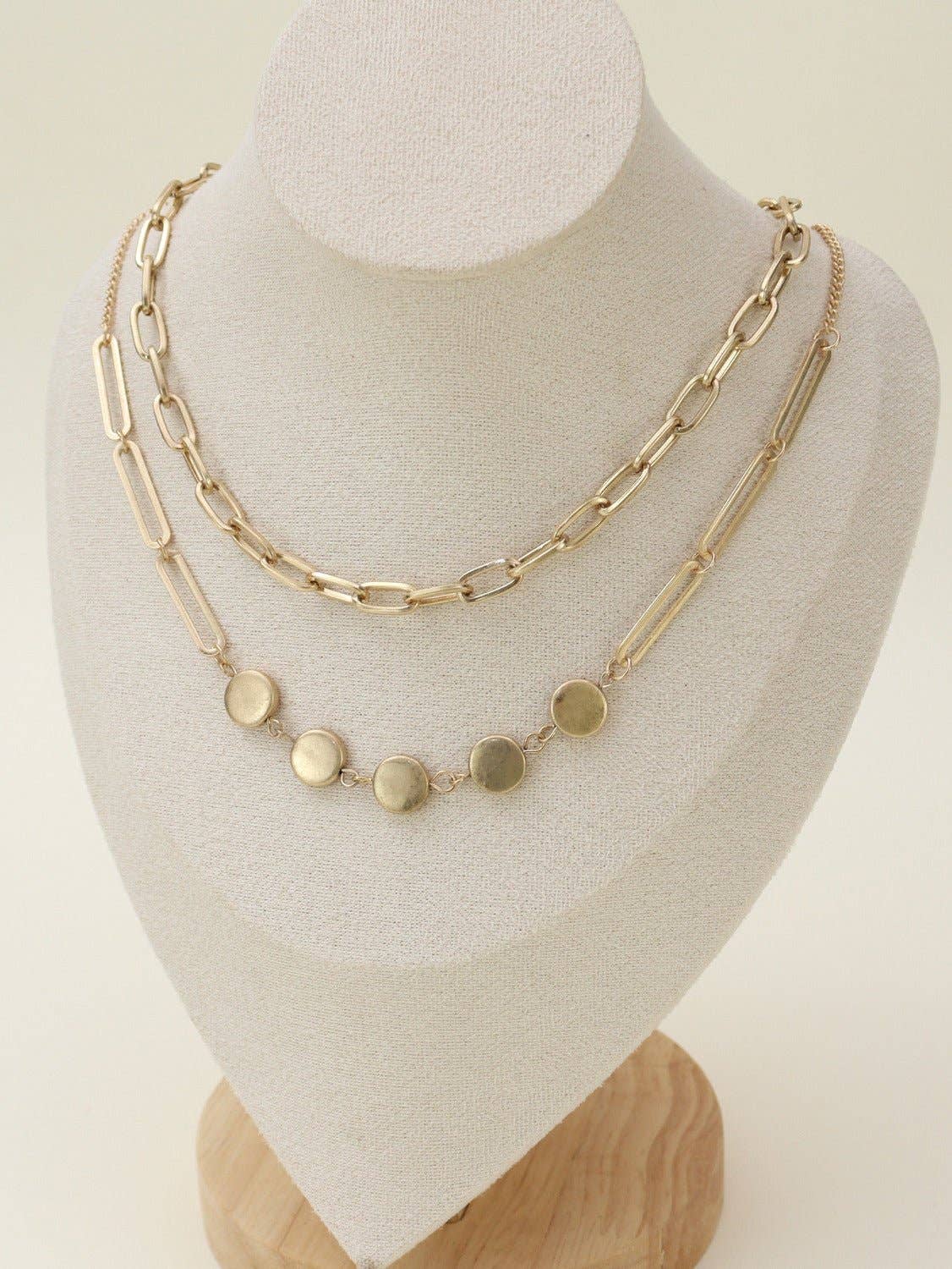Two Layer Chain Necklace Set displayed on a bust, featuring elegant gold chains and round pendant accents.