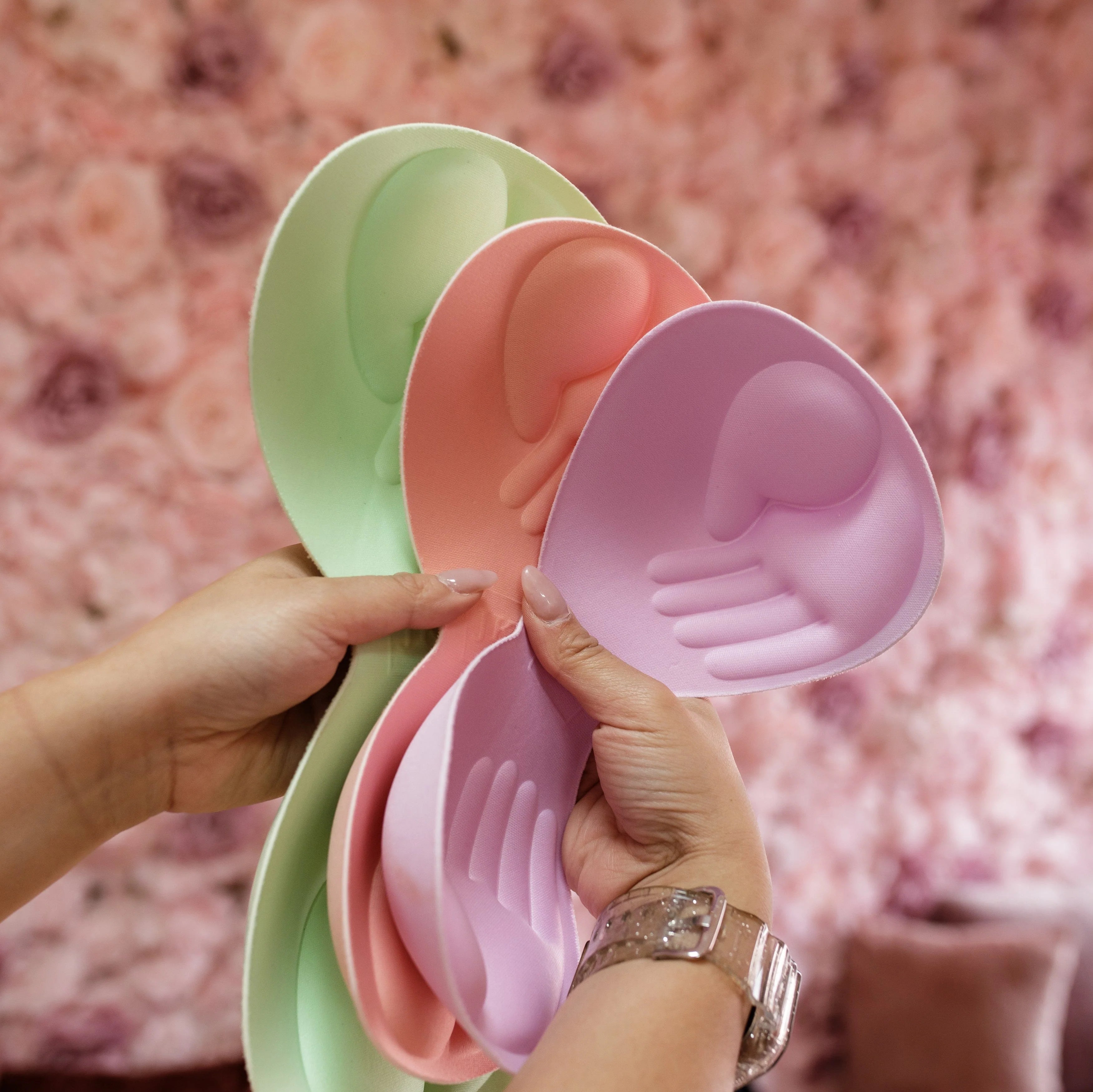 Colorful helping hands pads for JadyK bralettes in peach, green, and lavender.