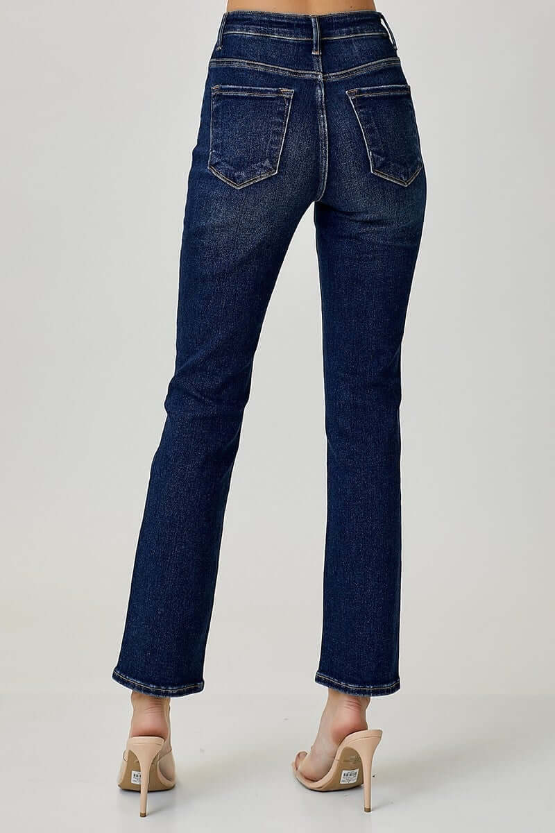 Back view of midrise Adeline jeans by Risen in dark wash, styled with heeled sandals for a chic look.