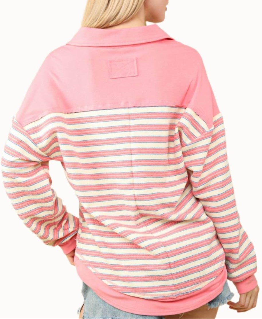 Model showcasing the back of an oversized striped knit top in pink, perfect for early fall layering.