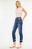 Model wearing Kancan Georgia ultra high rise slim straight leg jeans with a casual top and sneakers.