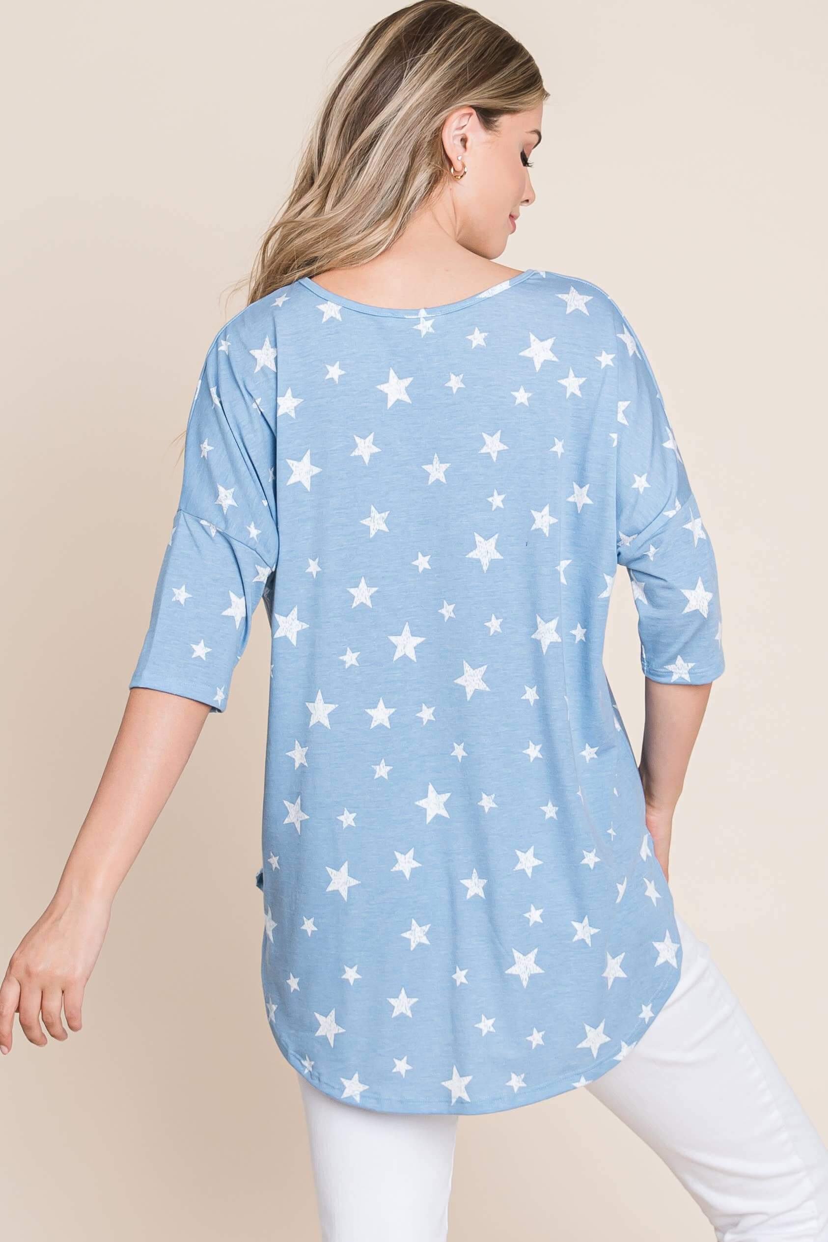 Back view of a relaxed blue tunic top with white star print, perfect for casual outings and comfortable wear.