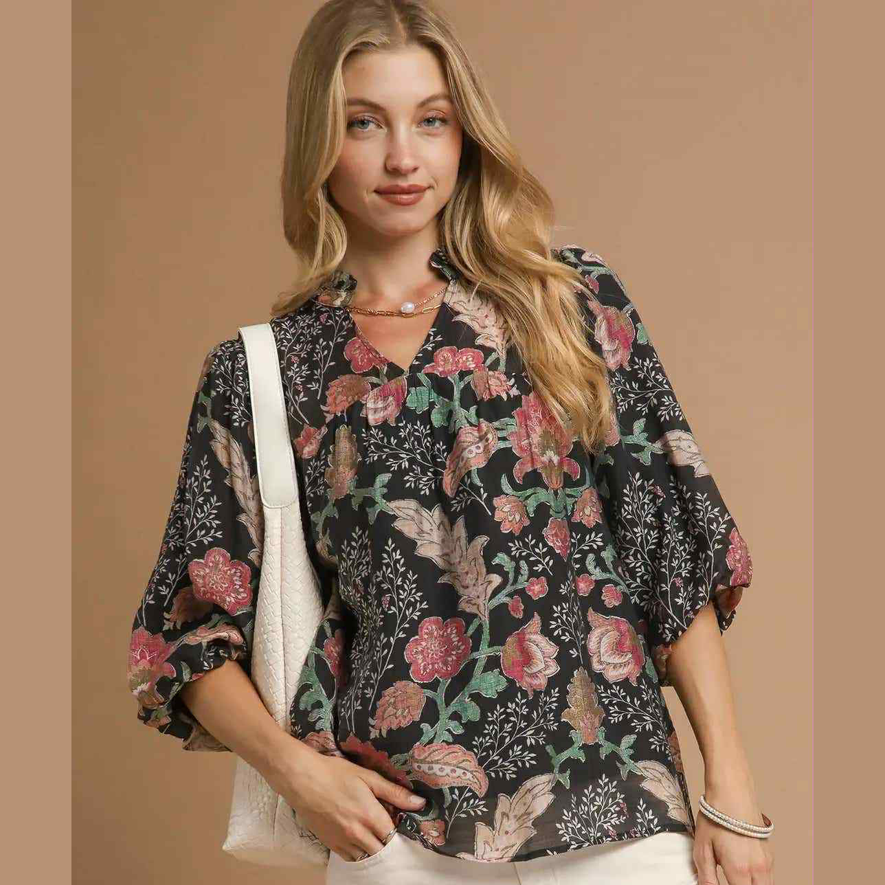 Model wearing the FOREVERMORE TOP - Umgee with floral print and puff sleeves, perfect for versatile fashion styling.