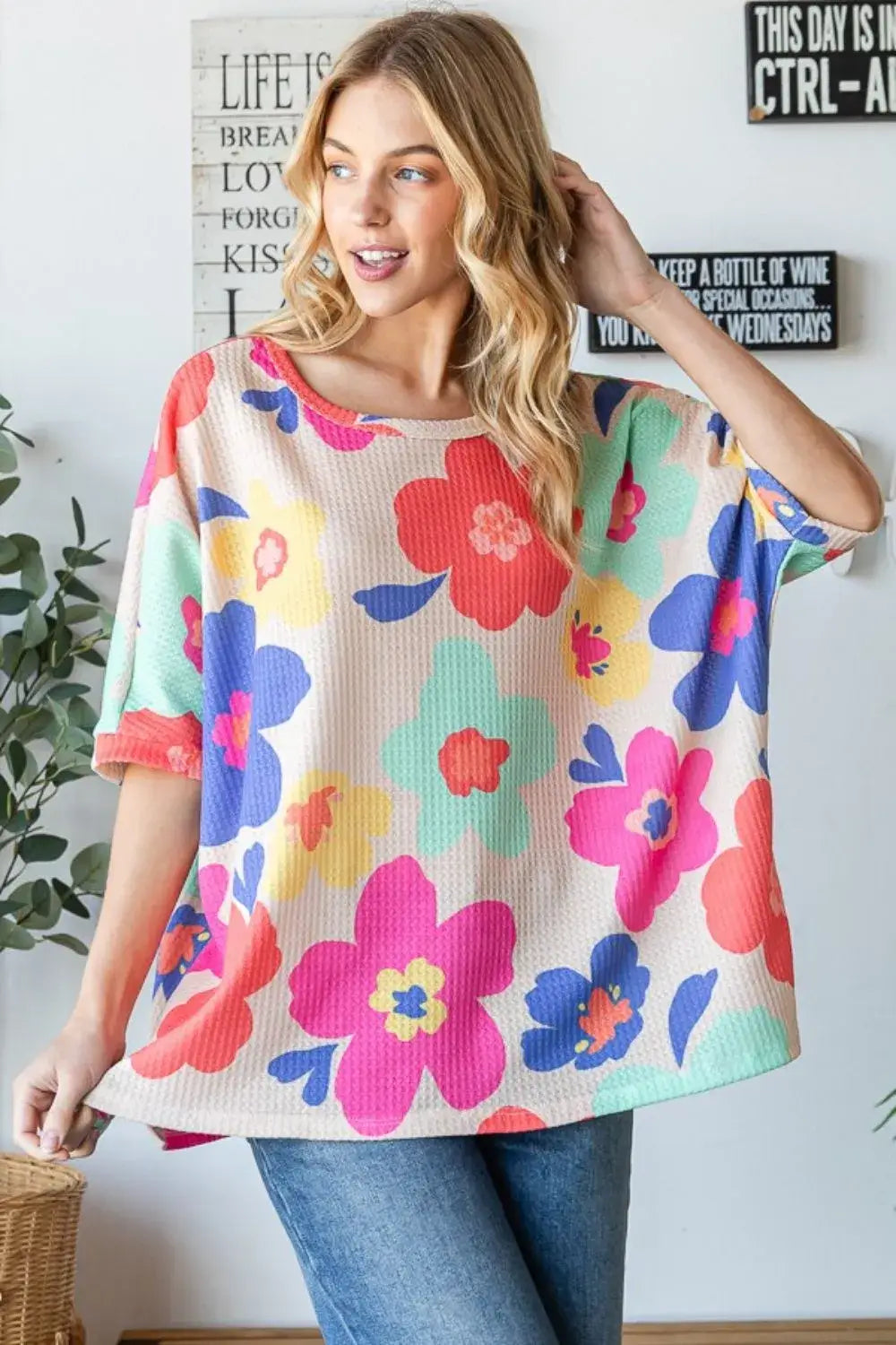 Floral oversized top in bright colors, perfect for a whimsical outfit with 'flower power' vibes.