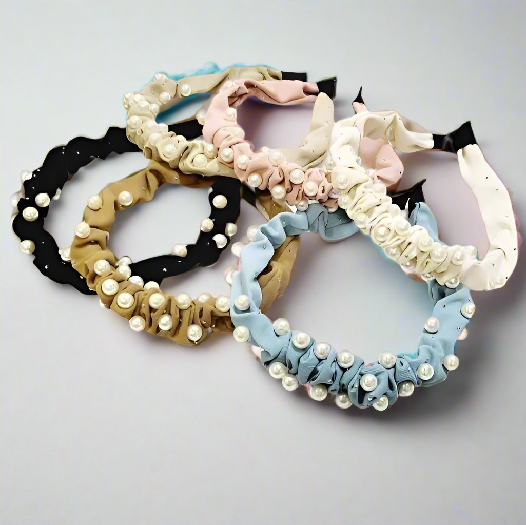 Assorted wrinkled pearl accent headbands in black, gold, pink, and blue styles, perfect for stylish hair accessory collections.