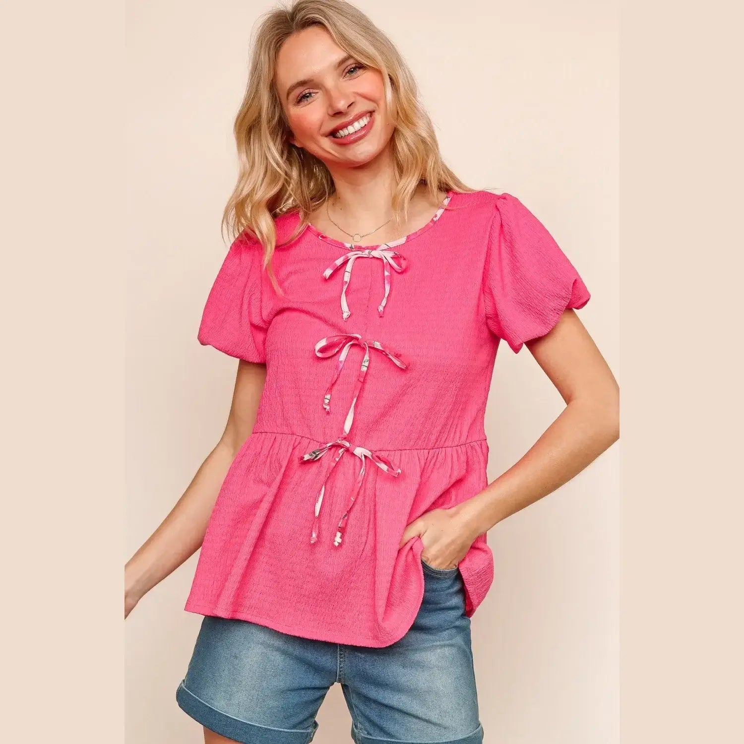 Playful pink RibbonS & Beaus Top with ribbon bows and flutter sleeves, perfect for summer outfits.