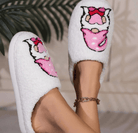 HUGS & HEARTS SLIPPERS with a cute embroidered character in a pink hat and pants, made of fluffy white sherpa.