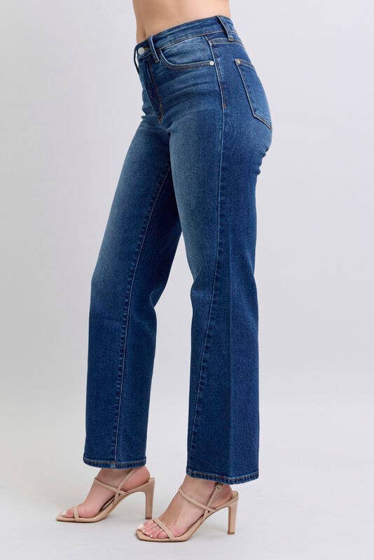 Model wearing JUDY BLUE - NOELLE JEANS in dark wash with high-rise fit and wide leg straight cut.