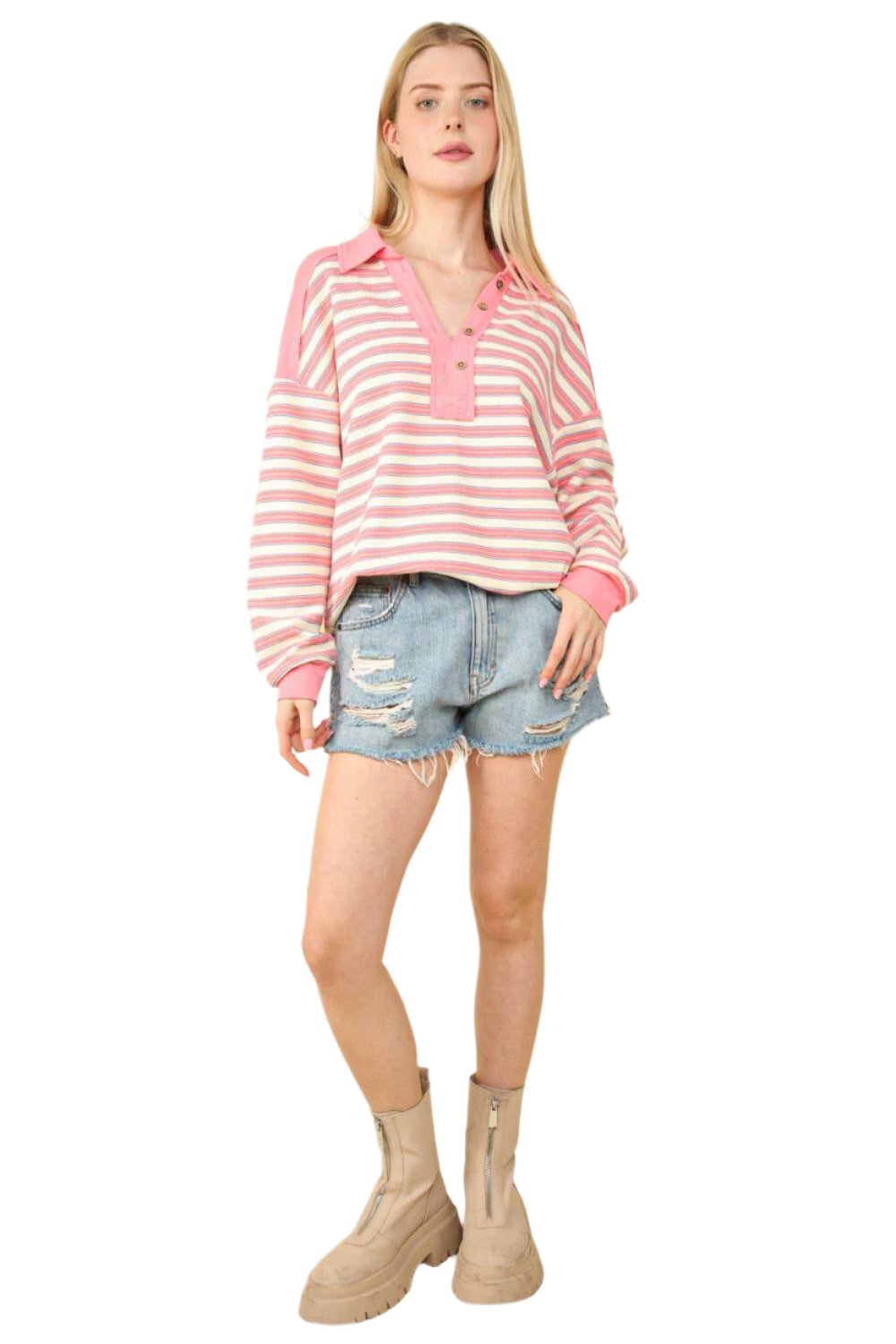 Oversized casual striped knit top in pink worn with distressed denim shorts, perfect for early autumn style.