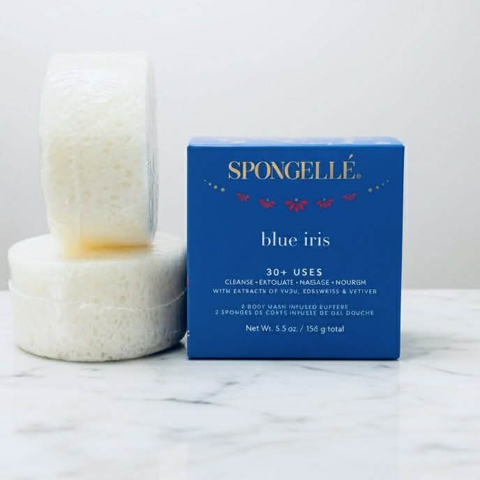 BLUE IRIS DUO BY SPONGELLE body wash infused buffers set with luxury packaging and exfoliating sponges on marble surface.