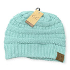 Teal knit beanie by C.C. with suede patch, showcasing cozy and stylish winter fashion.