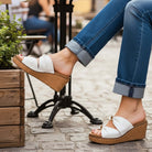 CORKYS - MISS UNDERSTOOD WEDGES showcased with ivory double bow on a cork wedge in a stylish outdoor setting.