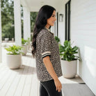 Stylish woman wearing the NATURAL EDGE TOP in chic leopard print, showcasing modern casual fashion.