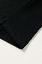 Close-up of the hem and sleeve of a black t-shirt, showcasing the soft cotton blend fabric and quality stitching details.