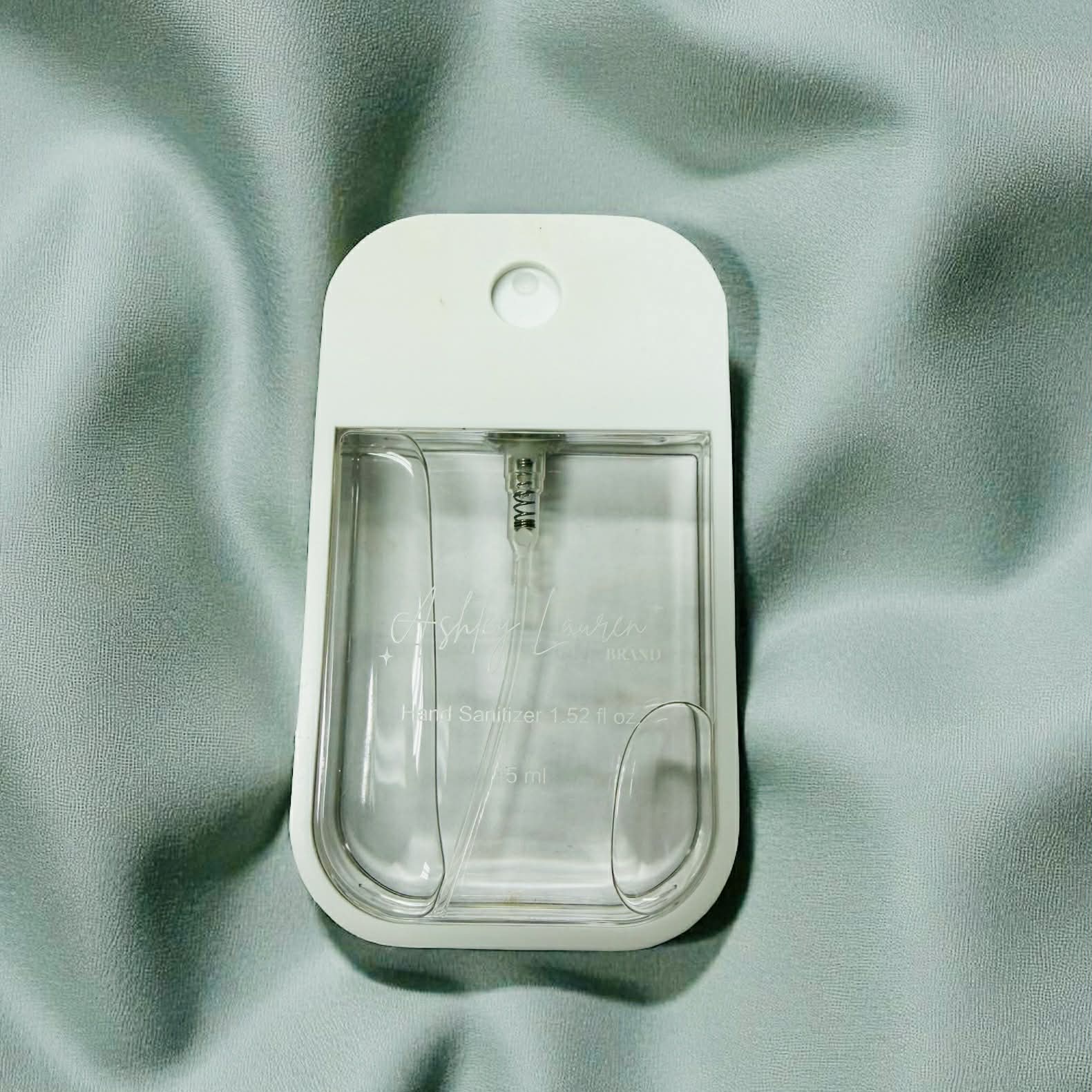 ASHLEY LAURA XL SUGAR COOKIE HAND SANITIZER bottle with sprayer on soft fabric background.