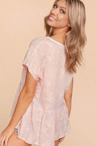Back view of a woman in a pink embroidered Grace & Glam Top by Haptics with a flowy babydoll silhouette.