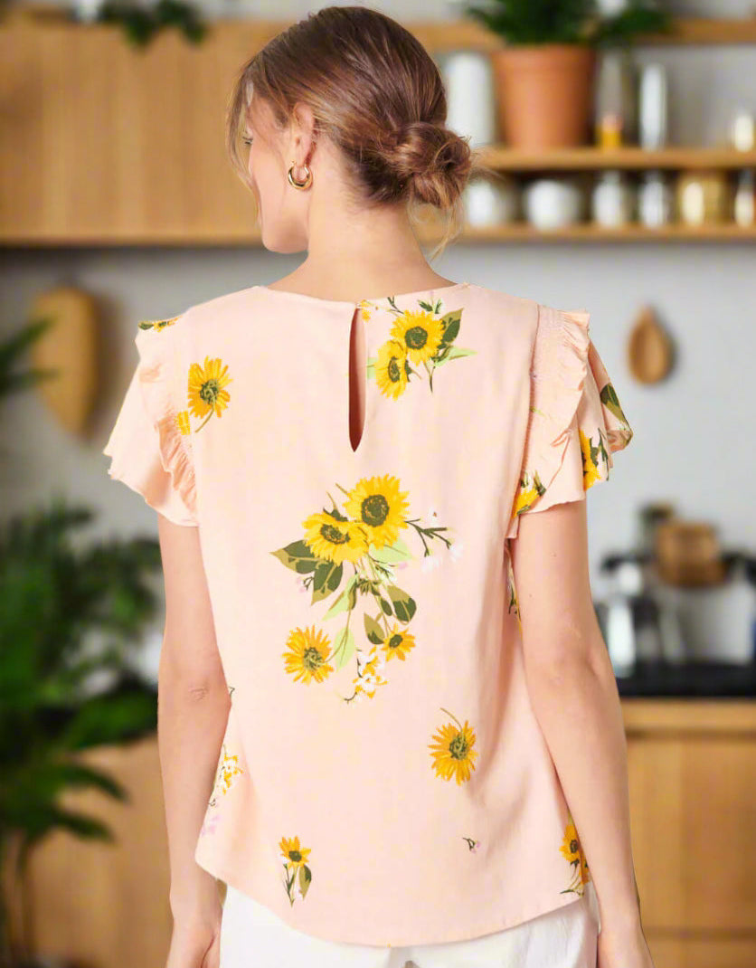 Back view of the DAISY MARIE TOP by SugarLips featuring sunflower print and ruffle sleeves, perfect for spring style.