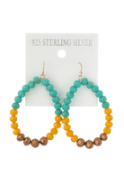 Colorful beaded hoop earrings in turquoise, yellow, and brown on a sterling silver card, perfect for casual wear.
