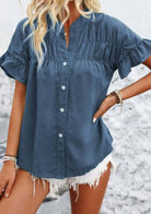 Trendy CLOUD CHASER TOP in blue, featuring ruffled sleeves and button details, perfect for casual summer outfits.