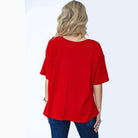 Back view of Draw The Line Top by Andrée in red, showcasing a relaxed and oversized boyfriend fit.