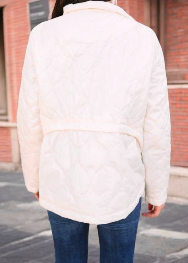 Back view of Umgee Wonderland puffer jacket in "glazed snowflake" shade, showcasing its stylish design and flattering fit.