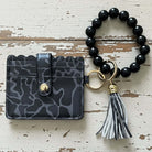 LULU MAC DK CAMO WRISTLET featuring dark camo design and stylish beaded wrist strap for hands-free convenience.