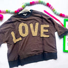 LOVE UNTAMED TOP - Easel featuring leopard print letters on a comfy dark wash oversized top.