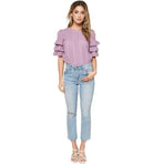 Mauve Sugar Eyelet Top with ruffle sleeves styled with light wash jeans and sandals.